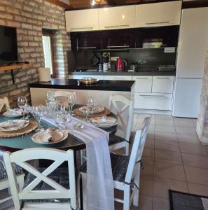 a kitchen with a dining table with glasses on it at Vila Stancevic wellness in Sremski Karlovci