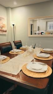 a table with white plates and glasses on it at Hamilton Central 3BR Family House in Hamilton