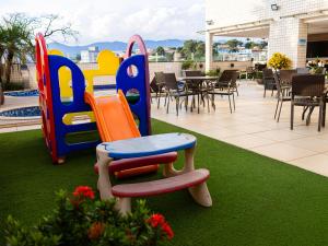 a childrens playground with colorful chairs and tables at Ville de Montagne Hotel in Brumadinho