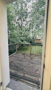 an open door to a deck with a view of trees at Hamilton Central 3BR Family House in Hamilton