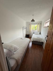 a bedroom with two beds and a window at Stay at 48 in Oulton