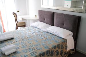 a bedroom with a large bed with a large headboard at VillaCycas in Casal Taulero