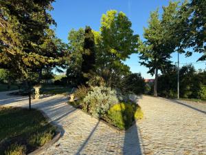 a garden with flowers and trees in a park at VillaCycas in Casal Taulero +1 photo