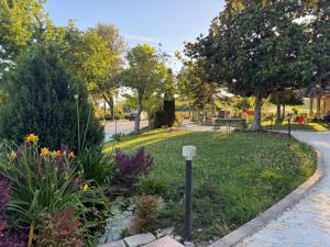 a garden with flowers and a path in a park at VillaCycas in Casal Taulero