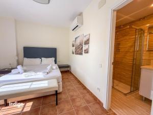 a bedroom with a bed and a walk in shower at Beachfront Apartment - Sea View - COU02 in Ayamonte +25 photos