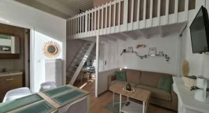 a living room with a couch and a staircase at Casa Verde in Berck-sur-Mer