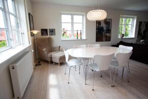 a dining room with a white table and chairs at Luxurious, spacious apartment - Nordic Style in Copenhagen +38 photos