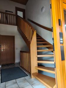 a wooden staircase in a room with a door at Ferienwohnung am Keltenwall in Jestetten