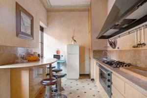 a kitchen with a white refrigerator and a counter at Casa Alighieri 2 in Levanto