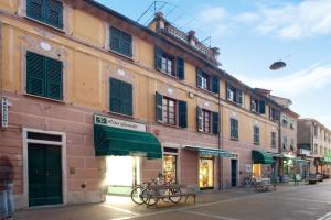 a building with green awnings on a city street at Casa Alighieri 2 in Levanto