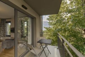 a room with a balcony with a table and chairs at Canopee 206 - by Care Concierge in Saint-Gervais-les-Bains