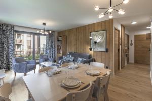 a dining room and living room with a table and chairs at Canopee 206 - by Care Concierge in Saint-Gervais-les-Bains