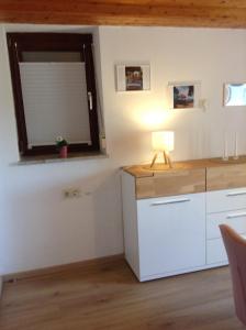 a room with a table with a lamp and a window at Terassenwohnung in Starzach +12 photos