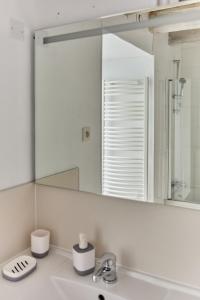 a bathroom with a sink and a mirror at La Breizhidence in Combourg +29 photos