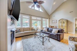a living room with a couch and a ceiling fan at 4096 - Cake by the Ocean in Duck