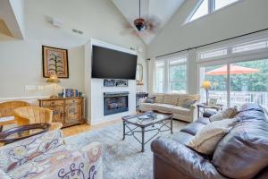 a living room with a couch and a tv at 4096 - Cake by the Ocean in Duck