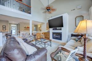 a living room with a leather couch and a fireplace at 4096 - Cake by the Ocean in Duck +71 photos