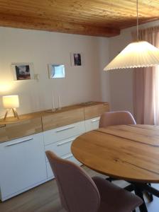 a kitchen with a table and chairs and a light at Terassenwohnung in Starzach