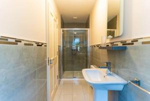 a bathroom with a sink and a shower at Old Rectory House - Waterville in Waterville +11 photos