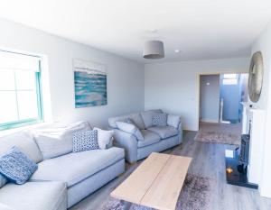 a living room with a couch and a table at Old Rectory House - Waterville in Waterville