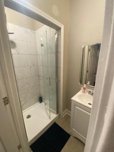 a bathroom with a shower and a sink at The Heart house in Indianapolis