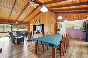 a living room with a green table and chairs at Wildlife, Waves Getaway in Acton Park