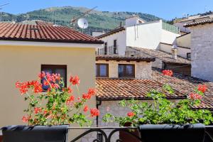 a view from the balcony of a house with red flowers at B&B Dimora Belvedere in Barisciano
