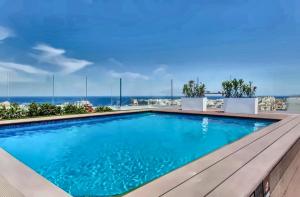 a swimming pool with a view of the ocean at Loft 23 Boutique Hotel in St. Julianʼs