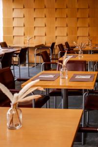 an empty classroom with wooden tables and chairs at Axis Ponte de Lima Golf Resort Hotel in Ponte de Lima +43 photos