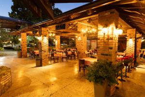 a patio with a restaurant with tables and chairs at Motel Stari Hrast in Markovac +105 photos