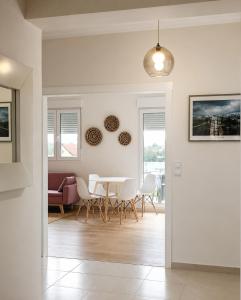 a dining room and living room with a table and chairs at Casa Candola in Noya