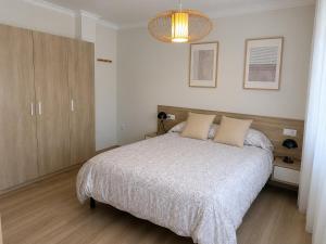 a bedroom with a large bed and a chandelier at Casa Candola in Noya