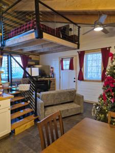 a living room with a loft bed and a couch at Cozy Christmas Cabin in North Pole