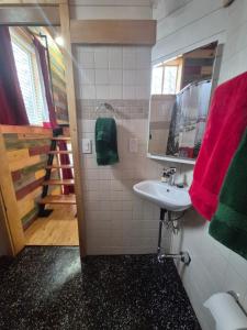 a bathroom with a sink and a mirror at Cozy Christmas Cabin in North Pole +6 photos