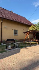 a picnic table and a picnic table in front of a building at Ріточка in Berehove +10 photos
