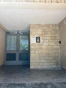 a door to a building with a brick wall at Studio Callatis Mangalia in Mangalia +7 photos
