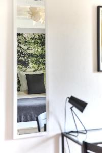 a mirror in a room with a bed at La Breizhidence in Combourg