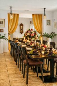 a long dining room with a long table and chairs at Secluded Vineyard Villa With Panoramic Views in Kojsko