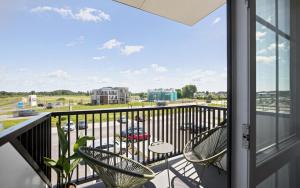 a balcony with chairs and a view of a parking lot at Barberry Apartments in Raadi