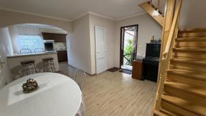 a living room with a table and a kitchen at Ріточка in Berehove