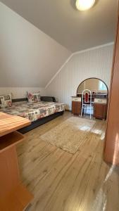 a bedroom with a bed and a desk and a table at Ріточка in Berehove