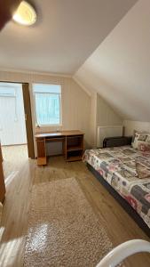 a bedroom with a bed and a desk in it at Ріточка in Berehove