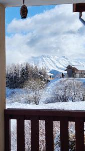 a view of a snow covered mountain from a window at Charmant Studio La Toussuire in La Toussuire