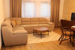 a living room with a couch and a table at GUZIJAN seosko domaćinstvo in Šipovo