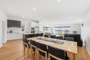 a dining room and kitchen with a table and chairs at Stylish Rosetta Waterview Stay in Rosetta