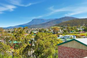 a view of a town with mountains in the background at Cosy Unit Near MONA in Claremont