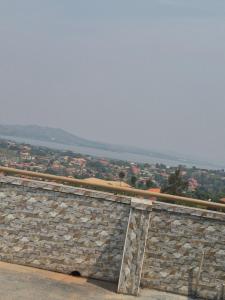 a stone wall with a view of a city at Dinah villas ug in Entebbe