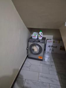 a washer and dryer in a corner of a room at Dinah villas ug in Entebbe