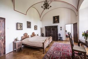 a bedroom with a bed and a chair and a table at Burg Bernstein in Bernstein +38 photos