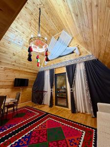 a living room with a table and a chandelier at A-Frame in Dolinka +16 photos